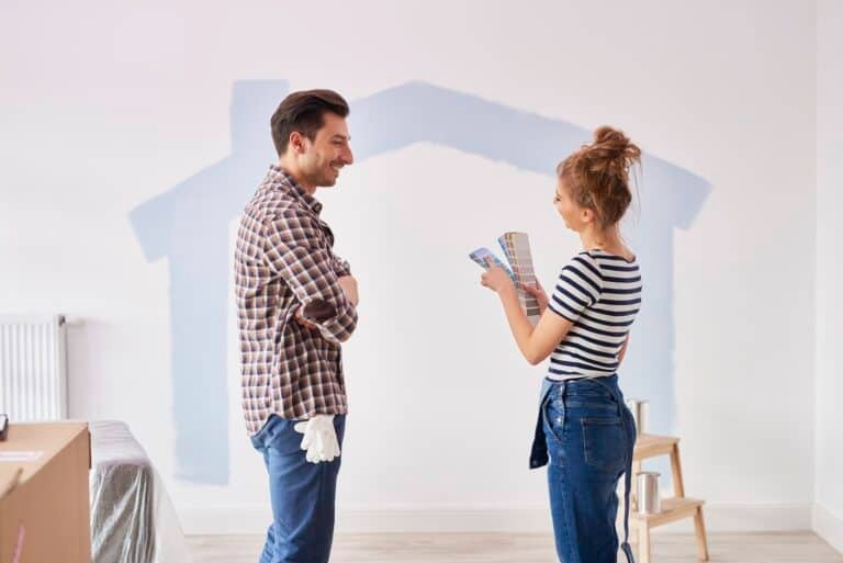 Couple painting new apartment interior walls